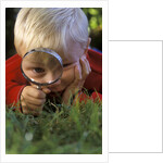 1980s Boy Using Magnifying Glass by Anonymous