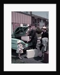 1950s Family Mother Father Daughter In Front Of Suburban House Packing Luggage In Car For Vacation by Anonymous