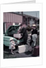 1950s Family Mother Father Daughter In Front Of Suburban House Packing Luggage In Car For Vacation by Anonymous