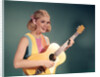 1960s Perky Young Teenager Folk Singer Playing Guitar by Anonymous