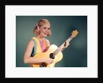 1960s Perky Young Teenager Folk Singer Playing Guitar by Anonymous