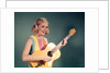 1960s Perky Young Teenager Folk Singer Playing Guitar by Anonymous
