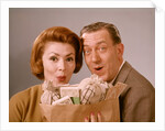 1960s Surprised Happy Couple Man Woman With Grocery Bag Filled With Money by Anonymous