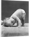 1940s Baby Bending Down With Head On Blanket by Anonymous