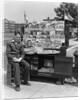 1940s Boy Sitting At Corner Newsstand Writing In Notepad by Anonymous