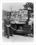 1940s Boy Sitting At Corner Newsstand Writing In Notepad by Anonymous