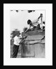 1930s Pair Of Boys Building Shack One Nailing Board To Side One On Roof With Saw by Anonymous