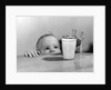 1950s Toddler Reaching Up To Table To Grab Milk Glass by Anonymous