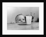 1950s Toddler Reaching Up To Table To Grab Milk Glass by Anonymous