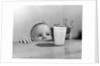 1950s Toddler Reaching Up To Table To Grab Milk Glass by Anonymous