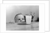 1950s Toddler Reaching Up To Table To Grab Milk Glass by Anonymous