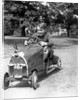 1930s Boy Driving Home Built Race Car Holding Steering Wheel by Anonymous
