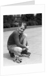 1930s Boy Fastening Metal Roller Skates by Anonymous