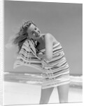 1950s 1960s Woman Wrapped In Stripped Towel Drying Hair On Beach Smiling by Anonymous