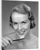 1950s Woman Holding Tooth Brush by Anonymous
