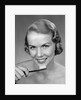 1950s Woman Holding Tooth Brush by Anonymous