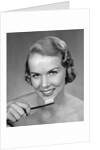 1950s Woman Holding Tooth Brush by Anonymous