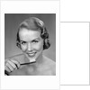 1950s Woman Holding Tooth Brush by Anonymous