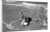 1960s Woman In Bathing Suit Lying In The Surf Holding A Beach Ball Outdoor by Anonymous
