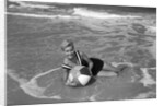 1960s Woman In Bathing Suit Lying In The Surf Holding A Beach Ball Outdoor by Anonymous