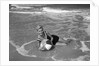 1960s Woman In Bathing Suit Lying In The Surf Holding A Beach Ball Outdoor by Anonymous