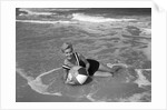 1960s Woman In Bathing Suit Lying In The Surf Holding A Beach Ball Outdoor by Anonymous