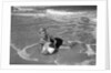 1960s Woman In Bathing Suit Lying In The Surf Holding A Beach Ball Outdoor by Anonymous