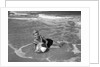 1960s Woman In Bathing Suit Lying In The Surf Holding A Beach Ball Outdoor by Anonymous