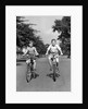 1930s 1940s Two Boys Riding Bikes On Tree Lined Street by Anonymous