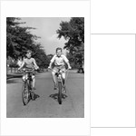 1930s 1940s Two Boys Riding Bikes On Tree Lined Street by Anonymous