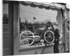 1950s Boy On Sidewalk Looking At Bicycle In Store Window by Anonymous