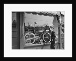 1950s Boy On Sidewalk Looking At Bicycle In Store Window by Anonymous