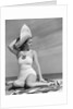1940s Woman In White Bathing Suit On Beach Wearing Big Straw Hat by Anonymous