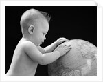 1940s Baby With Hands On Globe Looking At The Earth by Anonymous
