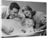 1950s Parents Leaning Over Tub Bathing Happy Baby by Anonymous
