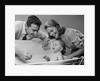 1950s Parents Leaning Over Tub Bathing Happy Baby by Anonymous