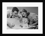 1950s Parents Leaning Over Tub Bathing Happy Baby by Anonymous