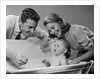 1950s Parents Leaning Over Tub Bathing Happy Baby by Anonymous