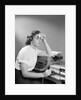 1950s Ailing Secretary Sitting At Desk With Typewriter And Dictation Machine Holding Handkerchief To Forehead by Anonymous