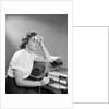 1950s Ailing Secretary Sitting At Desk With Typewriter And Dictation Machine Holding Handkerchief To Forehead by Anonymous