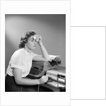 1950s Ailing Secretary Sitting At Desk With Typewriter And Dictation Machine Holding Handkerchief To Forehead by Anonymous