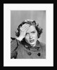 1950s Stressed Woman In Striped Dress Hold Forehead With Hand by Anonymous