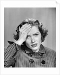 1950s Stressed Woman In Striped Dress Hold Forehead With Hand by Anonymous