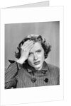 1950s Stressed Woman In Striped Dress Hold Forehead With Hand by Anonymous