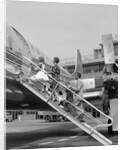 1950s Family Boarding Propeller Airliner By Climbing Gangway Stairs At Airport by Anonymous