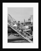 1950s Family Boarding Propeller Airliner By Climbing Gangway Stairs At Airport by Anonymous