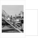 1950s Family Boarding Propeller Airliner By Climbing Gangway Stairs At Airport by Anonymous