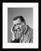 1960s Portrait Man In Suit and Tie With Wrinkled Brow Wincing and Holding Forehead by Anonymous