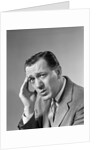 1960s Portrait Man In Suit and Tie With Wrinkled Brow Wincing and Holding Forehead by Anonymous