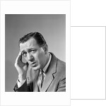 1960s Portrait Man In Suit and Tie With Wrinkled Brow Wincing and Holding Forehead by Anonymous